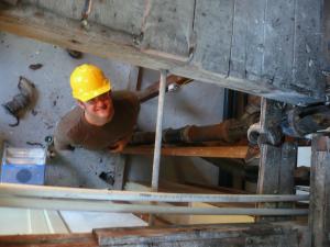 plumber in Walnut Creek looks up at a camera during a renovation