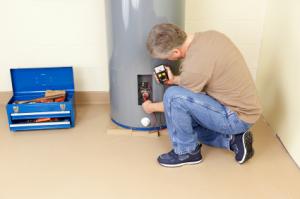 Walnut Creek water heater repair specialist checks the voltage on a 40 gallon water heater